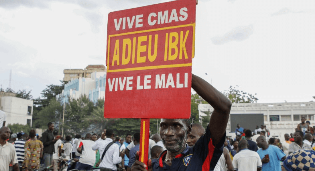 Man holding up a sign that says goodbye to the former President Ibrahim Boubacar